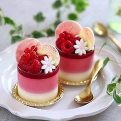 two desserts on a white plate with gold spoons