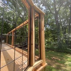 a wooden deck in front of some trees