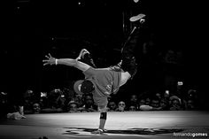 a man doing a handstand in front of a crowd