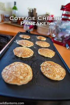 some pancakes are sitting on a pan with the words cottage cheese pancakes in front of them