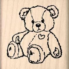 a rubber stamp with a teddy bear holding a heart on it's chest and the word love written in black ink