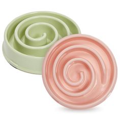 two pastel colored bowls with spiral designs on them, one is green and the other is pink