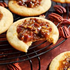 cookies with pecans and caramel toppings on a cooling rack