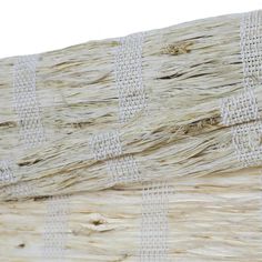 close up view of woven fabric on the outside of a wooden structure with white stripes