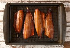 three pieces of fish sitting on top of a grill