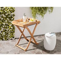 an outdoor table with drinks and fruit on it