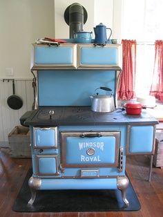 an old fashioned blue stove in a kitchen