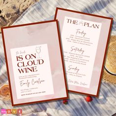 two wine menus sitting on top of a blanket next to a hat and straw hat