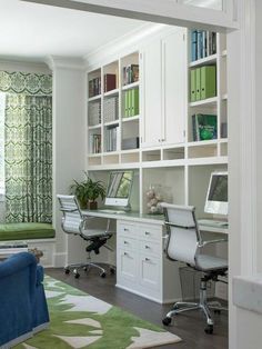 a living room filled with furniture and bookshelves next to a green rug on top of a hard wood floor