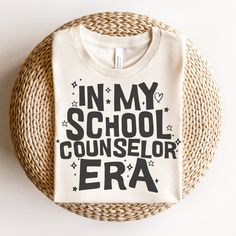 a white t - shirt with the words in my school counselor era printed on it