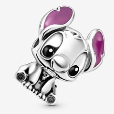 a silver charm with pink hearts on it's face and eyes, sitting in front of a white background