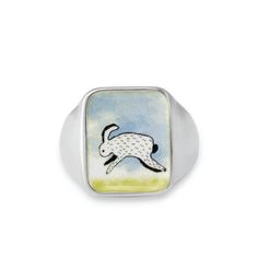 This wild rabbit ring is like a tiny painting. Unique and masculine with a hidden rainbow just for you. We call it the "field bunny" here in my workshop. Built for comfort, this hefty sterling silver signet ring looks great on a pinky finger or wear it big and bold on your ring , middle or index finger.  My original drawing is screen printed and fired on three layers of vitreous enamel at 1400 degrees making for a waterproof, durable and vibrant finish. The face of the ring is 16mm across or 5/8 Mens Signet Ring, Rabbit Ring, Pinky Finger, Glass Store, Wild Rabbit, Modern Store, Painting Unique, Dog Ring, Wolf Jewelry