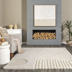 a living room with a white rug and a fire place in the middle of it