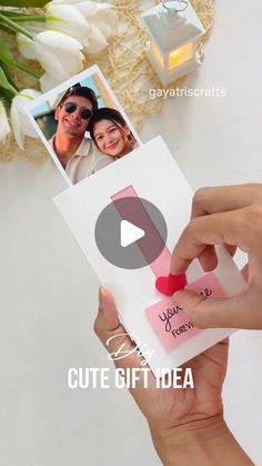 a person holding up a card with an image of two people on it and the caption says cute gift idea