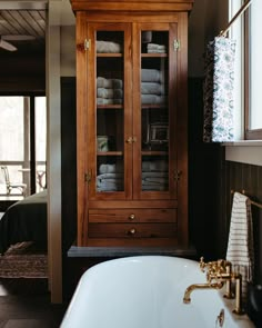 a bathroom with a tub and wooden cabinets