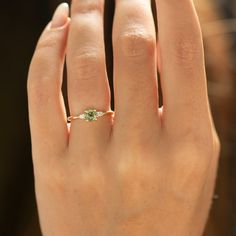 a woman's hand with a ring on it