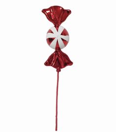 a red and white lollipop balloon with a bow on it's head