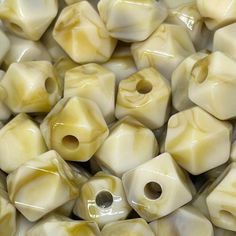 a pile of white and yellow ceramic beads