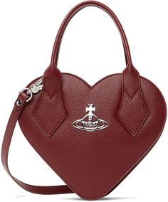 Heart-shaped grained faux-leather top handle bag in red. · Rolled carry handles · Adjustable and detachable crossbody strap · Logo hardware at face · Two-way zip closure · Card slot at interior · Twill lining · H7.5 x W9 x D2.75 Supplier color: Red Vivienne Westwood Heart Bag, Heart Shape Bag, Heart Shaped Purse, Heart Crossbody Bag, Vivienne Westwood Bags, Heart Purse, Vivienne Westwood Red, Heart Shaped Bag, Red Leather Bag