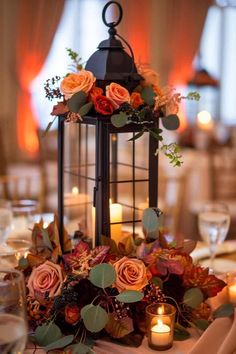 a lantern with candles and flowers on it