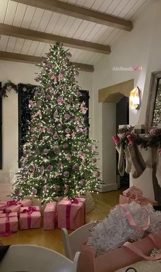 a decorated christmas tree with pink and white bows