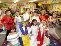 a group of children dressed in costumes posing for a photo