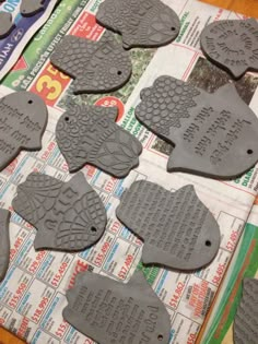 several fish shaped cookie cutters on top of a newspaper