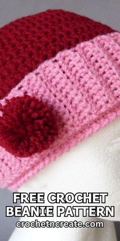 a crocheted hat with a red and pink pom - pom