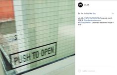 an image of a street sign on the side of a building that is being viewed through a window