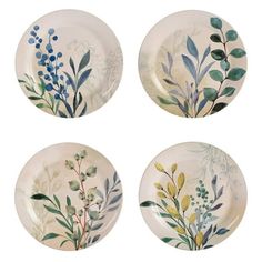 four plates with flowers and leaves painted on them