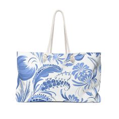 a blue and white floral print tote bag with rope handles on an isolated background