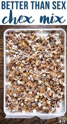 a glass dish filled with chocolate and marshmallows on top of a wooden table