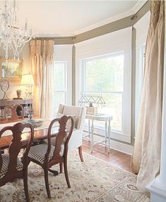 a dining room table with chairs and chandelier