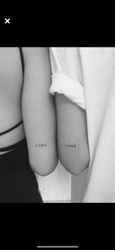 two people with small tattoos on their arms