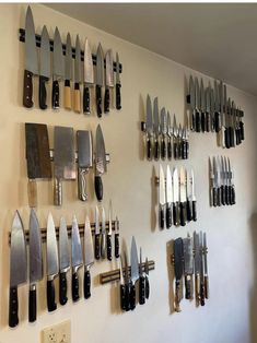 many knives are hanging up on the wall