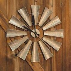 a large metal clock mounted to the side of a wooden wall