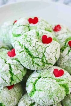 green and red cookies with hearts in the middle on a white plate for valentine's day