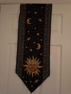 a sun and moon tie hanging on a door