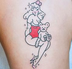 a woman with a teddy bear tattoo on her thigh