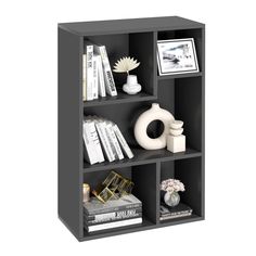 a book shelf with books, vases and pictures on it's sides in front of a white background