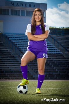 a female soccer player is posing for a photo