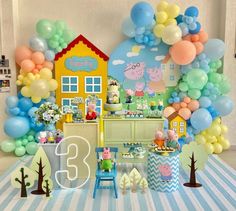 a birthday party with balloons, decorations and pep the pig theme on the wall is ready to be eaten