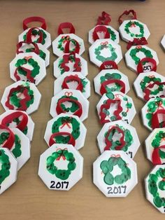 some paper plates with christmas wreaths on them and numbers in the shape of snowflakes