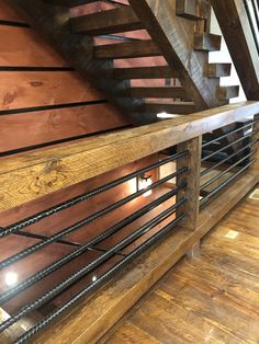 a wooden staircase with metal railings and wood flooring