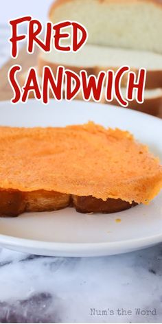 a piece of bread on a white plate with the words fried sandwich in front of it