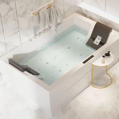 a bathtub in the middle of a bathroom with white tile walls and flooring