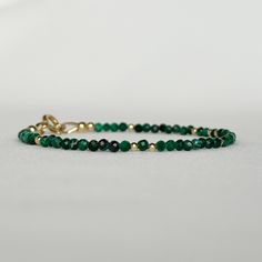 "Discover my minimalist and exquisitely natural emerald green malachite bracelet, elegantly made with 14k gold-filled or sterling silver accents, clasp and findings. This versatile gemstone beaded bracelet is perfect for layering or wearing on its own, achieving a minimalist aesthetic. A timeless jewelry piece that doubles as an ideal gift choice for engagements, weddings, birthdays, or anniversaries, suitable for moms, friends, girlfriends, teachers, or self-indulgence. DETAILS * Transformation Minimalist 14k Gold Filled Dangle Jewelry, Dainty Adjustable 14k Gold Jewelry, Adjustable Dainty 14k Gold Jewelry, 14k Gold Bracelet With May Birthstone, Adjustable Gold Gemstone Jewelry, Elegant Adjustable Bangle Jewelry, Adjustable Dainty 14k Gold Bracelet, 14k Gold Filled Bangle Jewelry For Gift, Faceted Yellow Gold Jewelry For May Birthstone