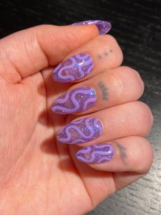 High quality press on nails. This set features a slightly sheer purple "jelly" glitter that reflects iridescent based on the lighting, with a subtle wavy line design that is more prominent based on lighting. Nails pictured are SHORT ALMOND shape. Photos show the nails photographed in different lighting to give the best possible representation (natural lighting, sunlight, and with flash). PLEASE READ: Use the nail sizing chart instructions from the photos to measure your nails. Then choose from the nail size options XS, S, M, or L. If your nails do not fit the standard sizes and you need custom sizing, please choose "CUSTOM" sizing and type in your custom sizes from thumb to pinky (ie. 1, 2, 3, 4, 5) under the "personalization" option. Please choose your length and shape. You can find an ex Trending Purple Nails, Lilac Purple Short Nails, Birthday Asthetic Nails, Long Nail Shape Ideas, Purple And Leopard Nails, Wiggly Nail Designs, Abstract Glitter Nails, Queer Nail Art Designs, Glitter Squiggle Nails