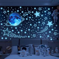 an image of a bedroom with stars and moon wall decals in the night sky