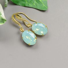 Pacific opal mint swarovski crystal earrings featuring a oval swarovski crystal in a gold plated setting on a gold plated cubic zirconia ear wire. These swarovski earrings are gorgeous. The depth of color is stunning and they sparkle from every angle. The mint green earrings are perfect for your bridesmaids earrings. Multiples available at checkout for your bridal party at dicounted pricing. If you don't see the quantity that you need, message me and I will make a listing for you. * pacific opal Mint Green Jewelry, Mint Green Bridesmaids, Gold Bridesmaid Necklace, Mint Necklace, Mint Green Earrings, Lexington Nc, Mint Earrings, Bridesmaid Gifts Jewelry, Earrings Bridesmaid